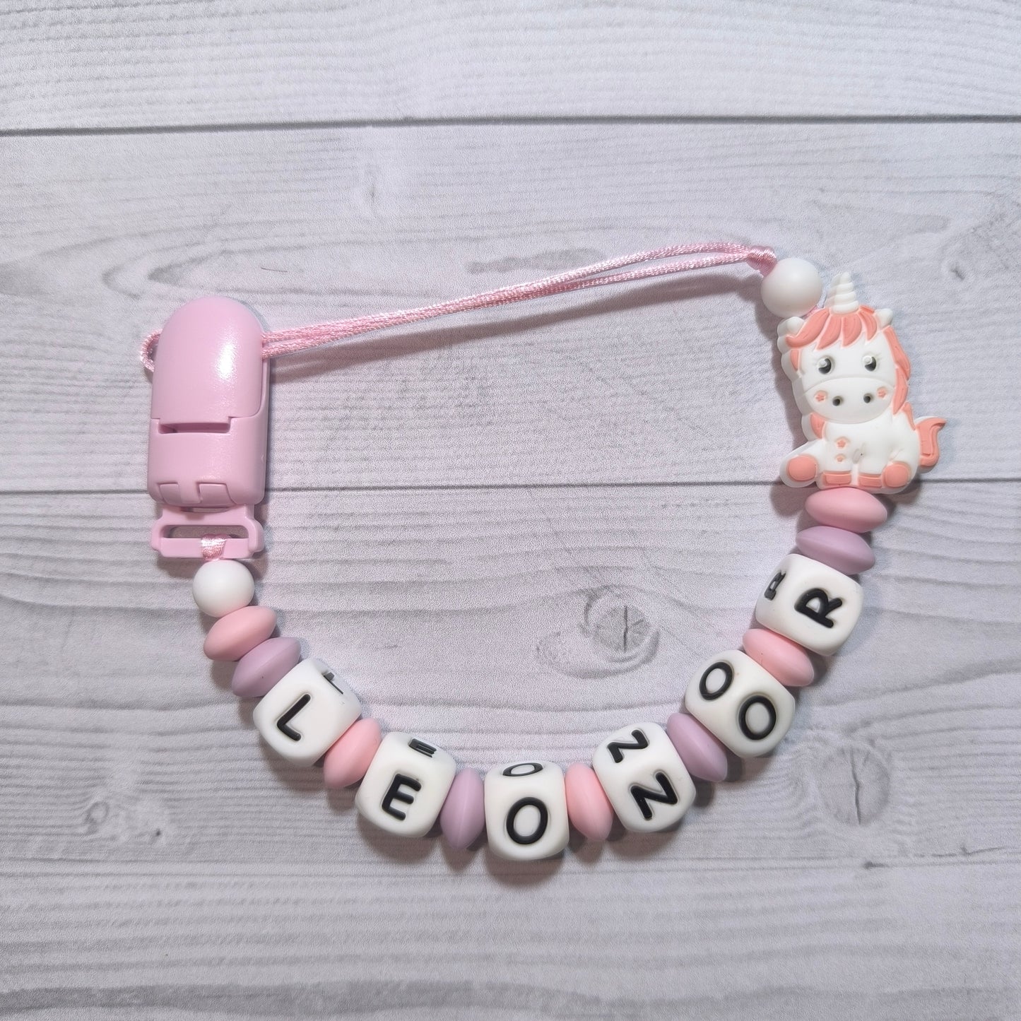 Chupetero + mordedor de Unicornio rosa con nombre.