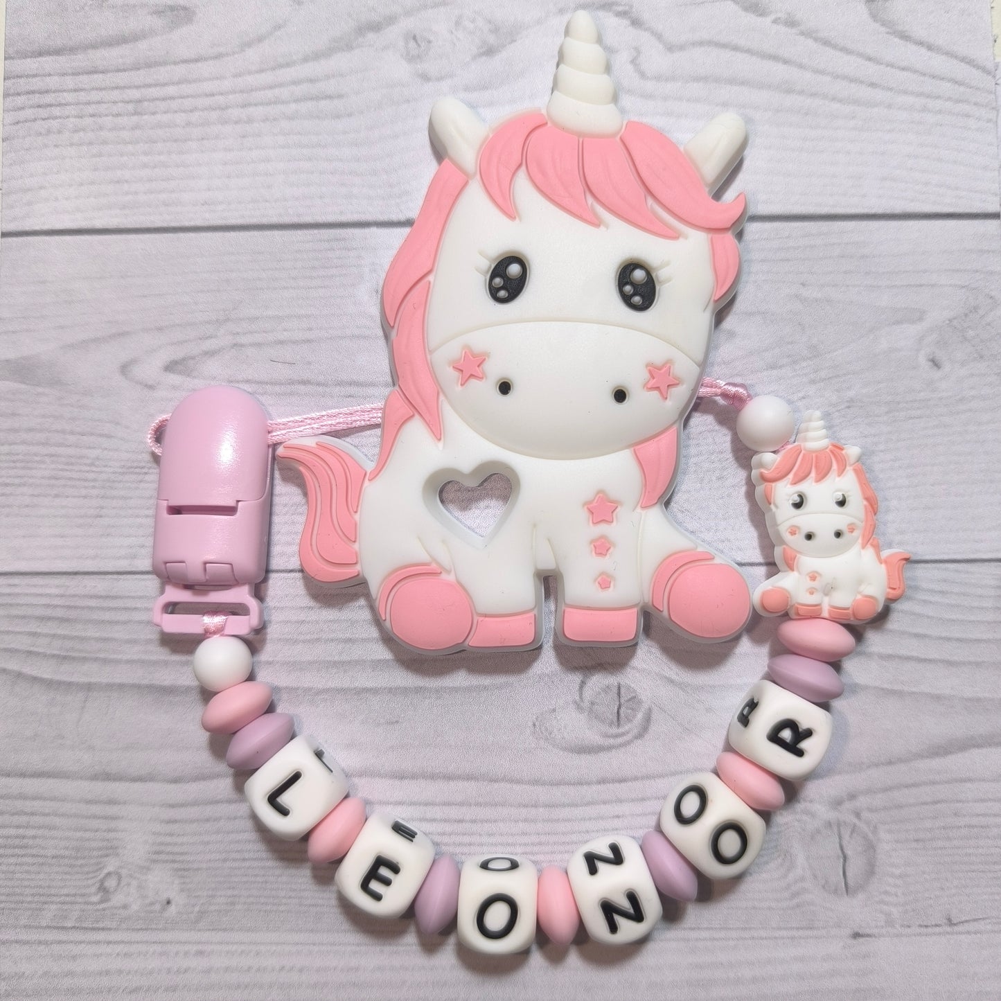 Chupetero + mordedor de Unicornio rosa con nombre.